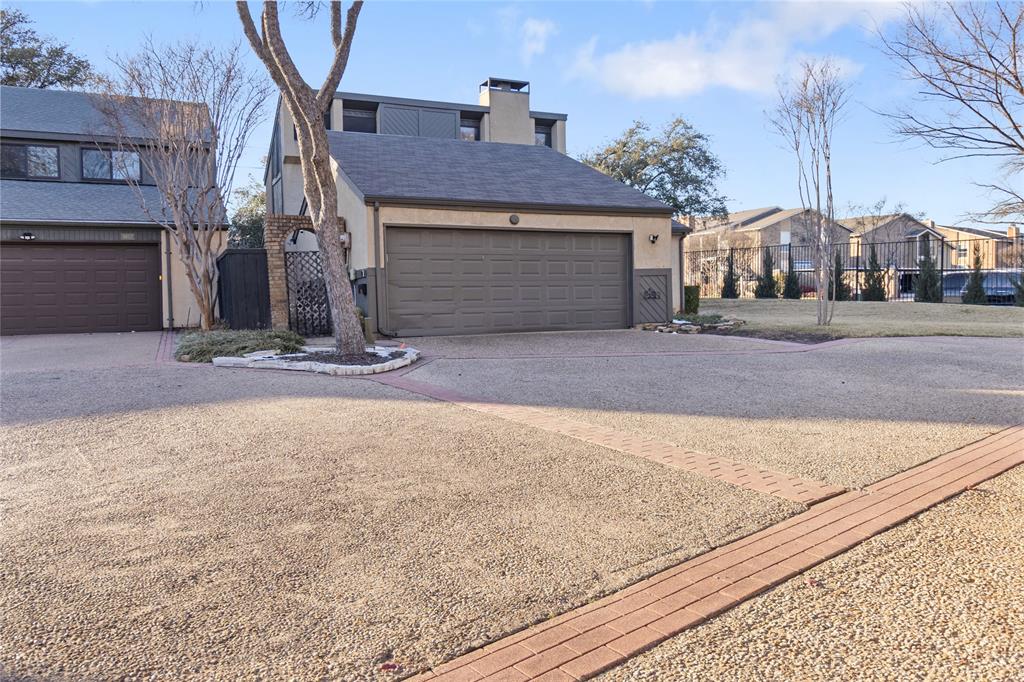 9611 Baseline Drive Dallas, TX 75243 - Photo 2 of 21 a front view of a house with a yard and garage