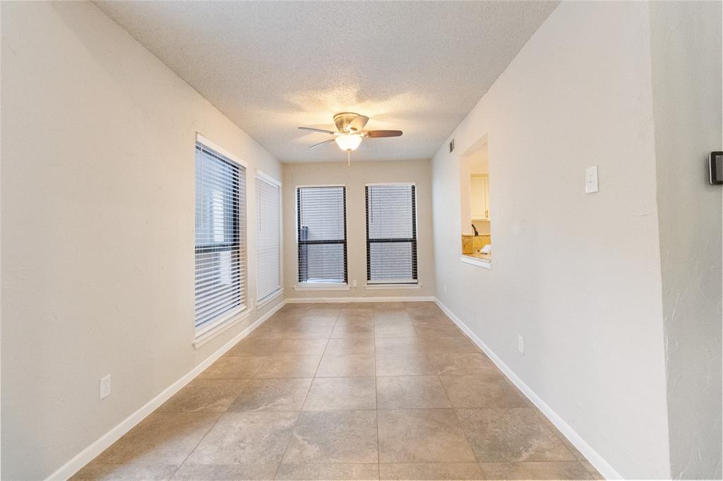 9611 Baseline Drive Dallas, TX 75243 - Photo 4 of 21 an empty room with windows and fan