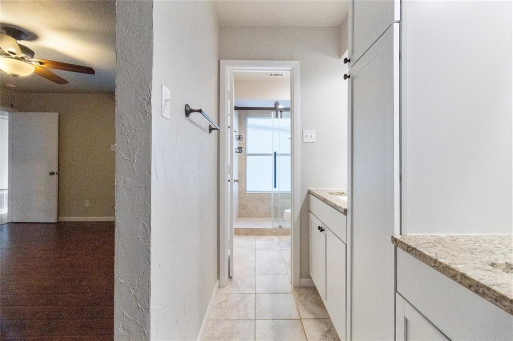 9611 Baseline Drive Dallas, TX 75243 - Photo 7 of 21 a bathroom with a granite countertop sink and a mirror
