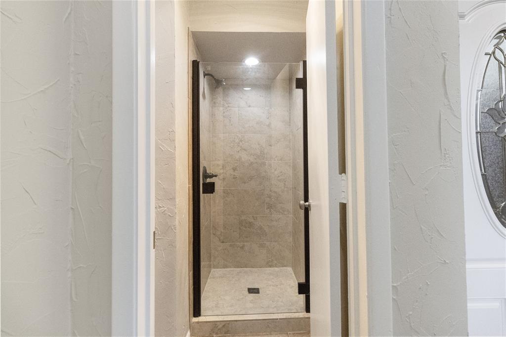 9611 Baseline Drive Dallas, TX 75243 - Photo 10 of 21 a bathroom with a glass shower door