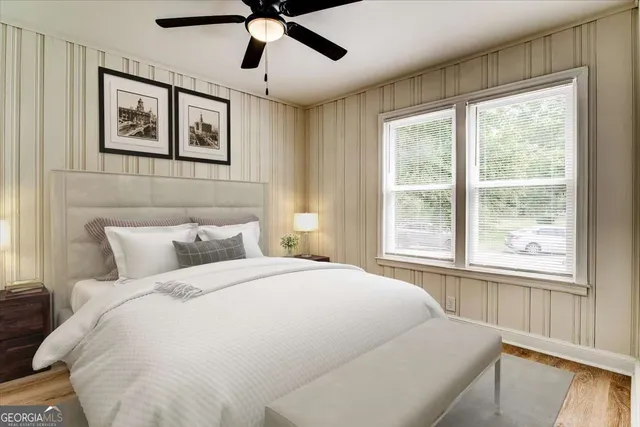 a large white bed in a bedroom next to a window