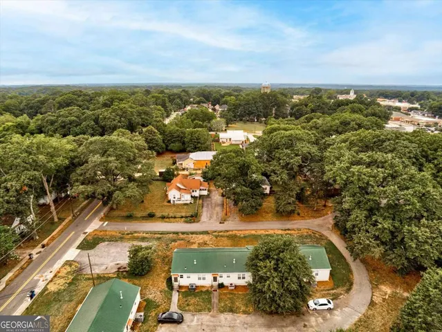 an aerial view of residential houses with outdoor space
