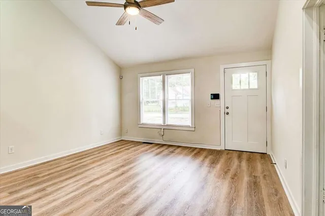wooden floor in an empty room with a window
