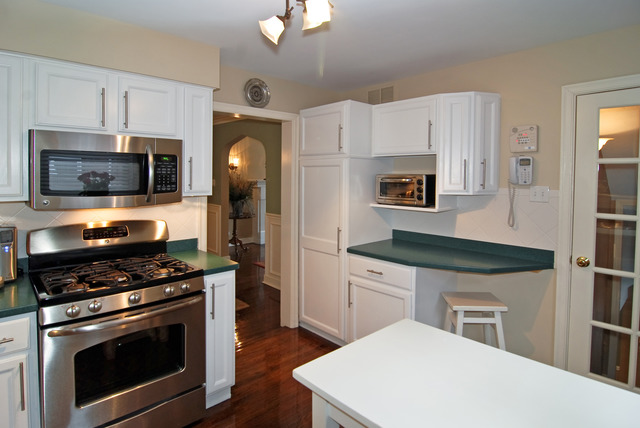 534 Byrd Road Riverside, IL 60546 - Photo 5 of 23 a kitchen with stainless steel appliances a stove microwave and refrigerator