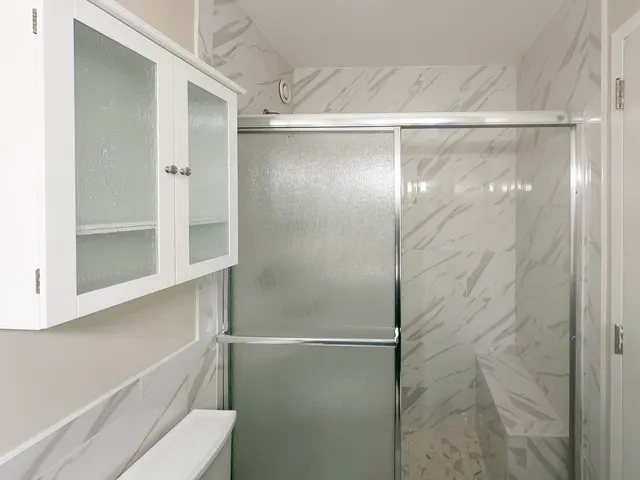 a bathroom with a glass shower door