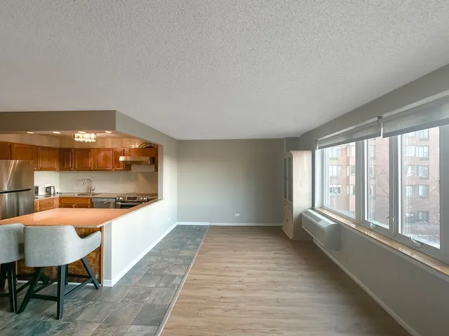 a view of a room with furniture and a large window