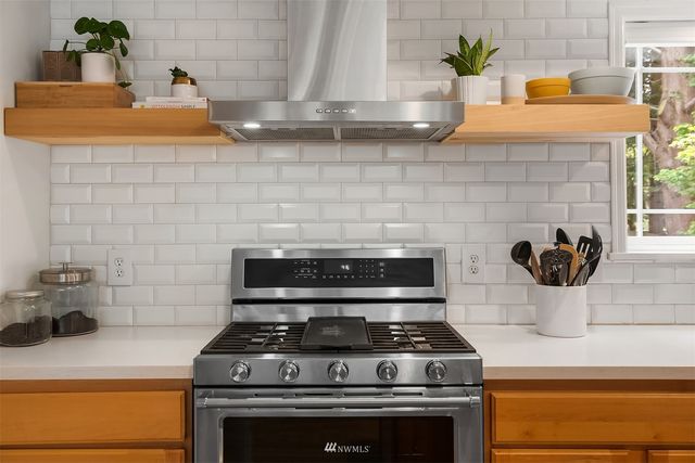 a stove top oven sitting inside of a kitchen