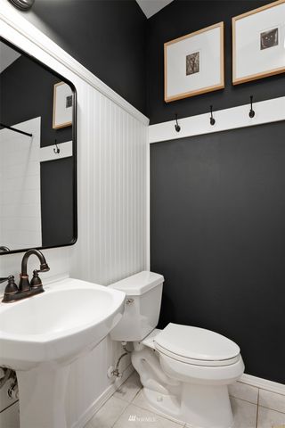 a bathroom with a sink toilet and mirror