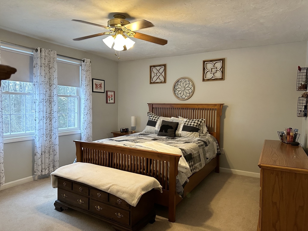 5 Debbie Drive Spencer, MA 01562 - Photo 30 of 30 a bedroom with a bed and a chandelier