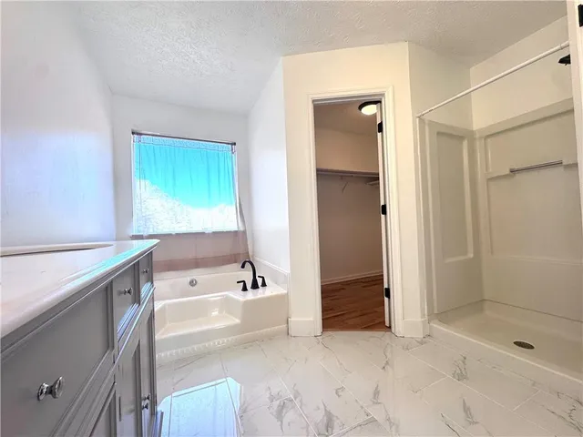 a bathroom with a bathtub and a shower