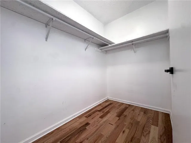 a view of a room with wooden floor