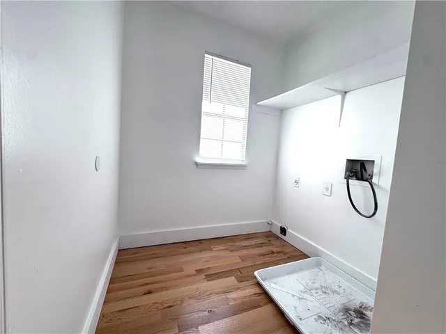 an empty room with a window and mirror