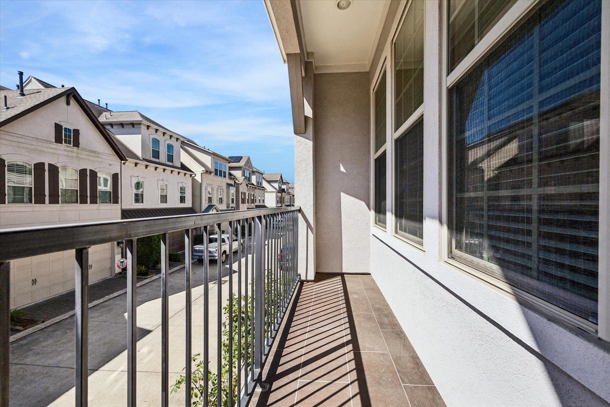 8318 Ginger Oak Street Houston, TX 77055 - Photo 17 of 20 a view of a balcony with wooden floor and stairs