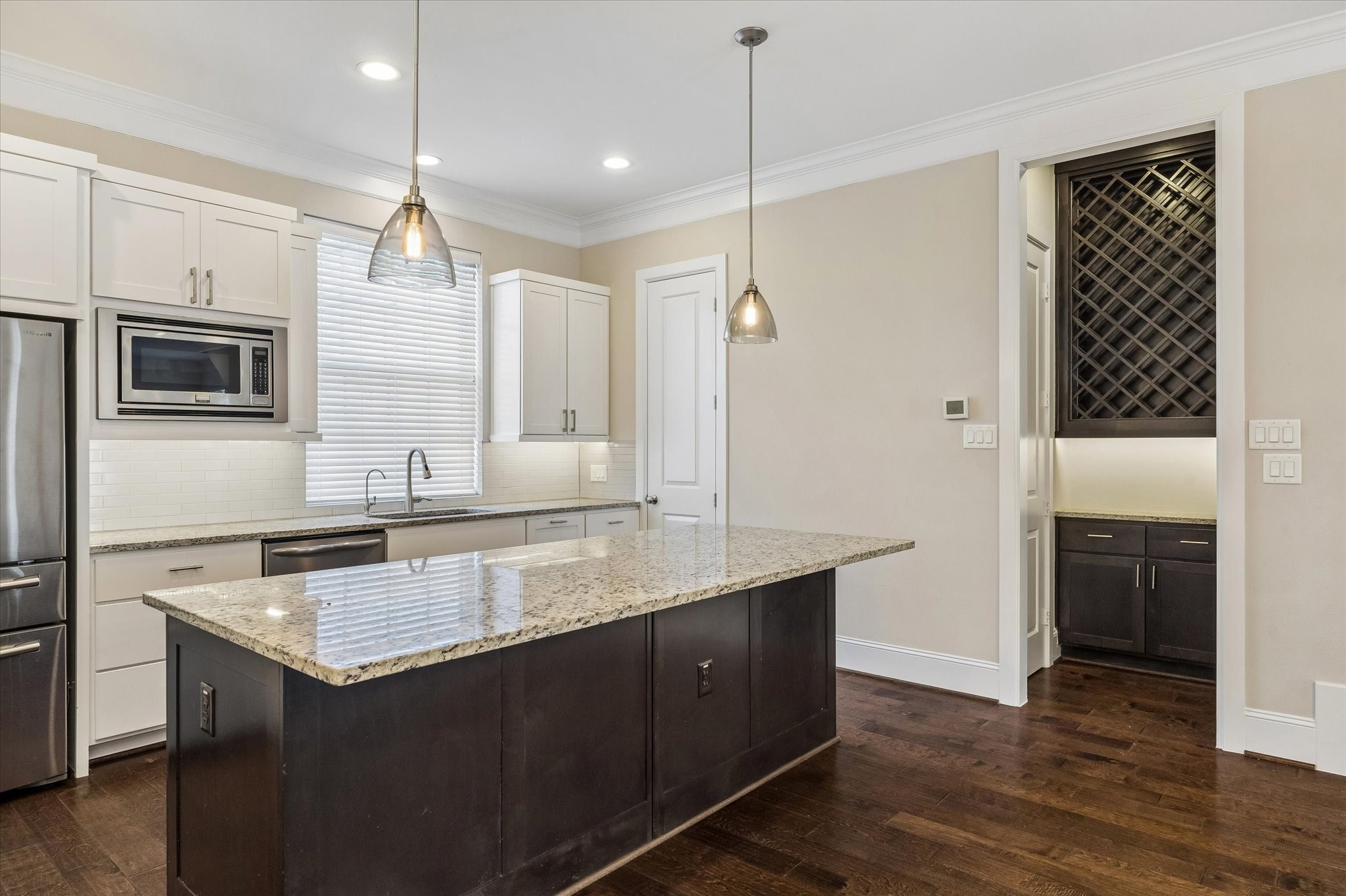 8318 Ginger Oak Street Houston, TX 77055 - Photo 5 of 20 a kitchen with a sink refrigerator and microwave