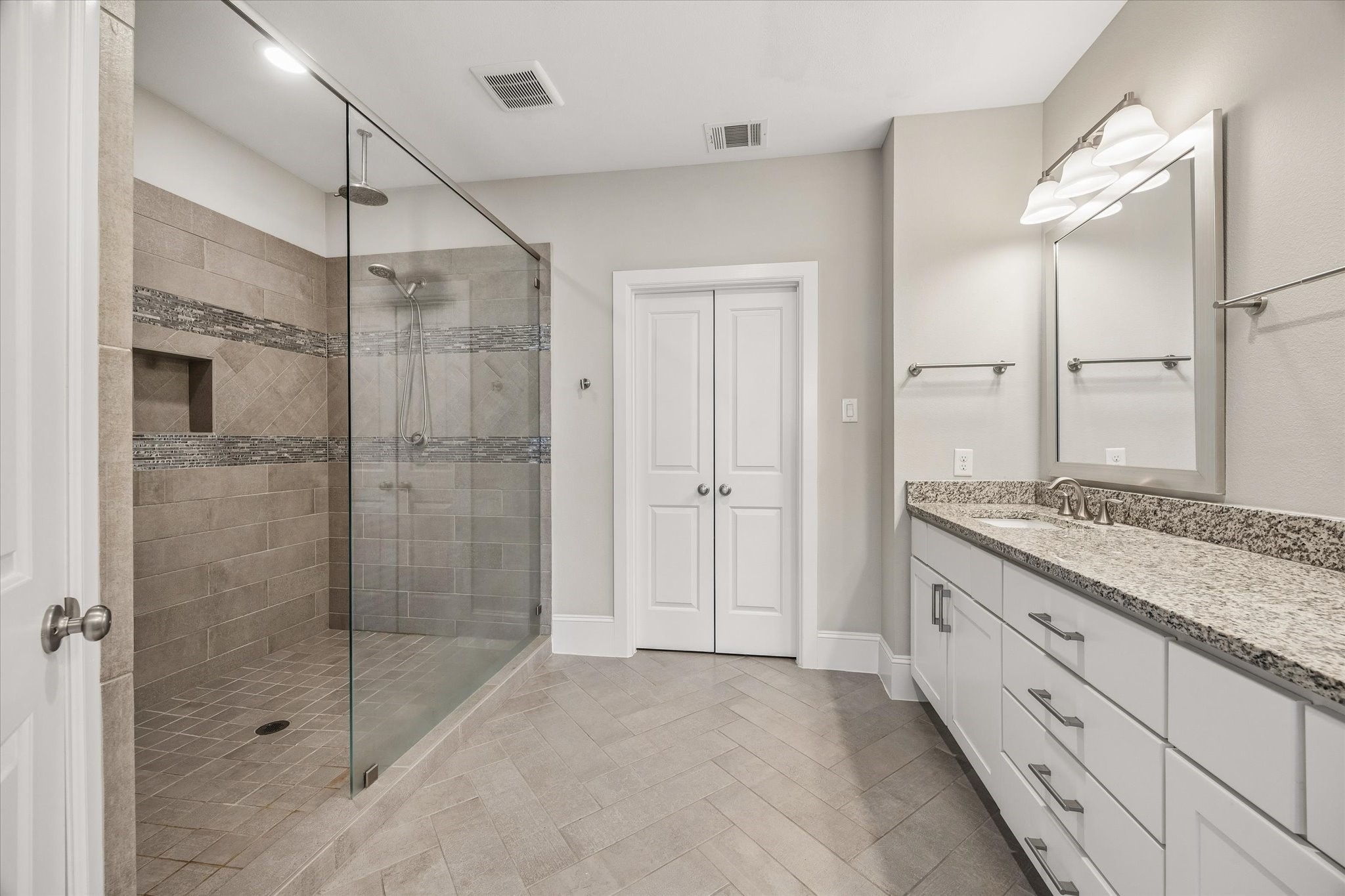 8318 Ginger Oak Street Houston, TX 77055 - Photo 9 of 20 a bathroom with a granite countertop sink a shower and a mirror