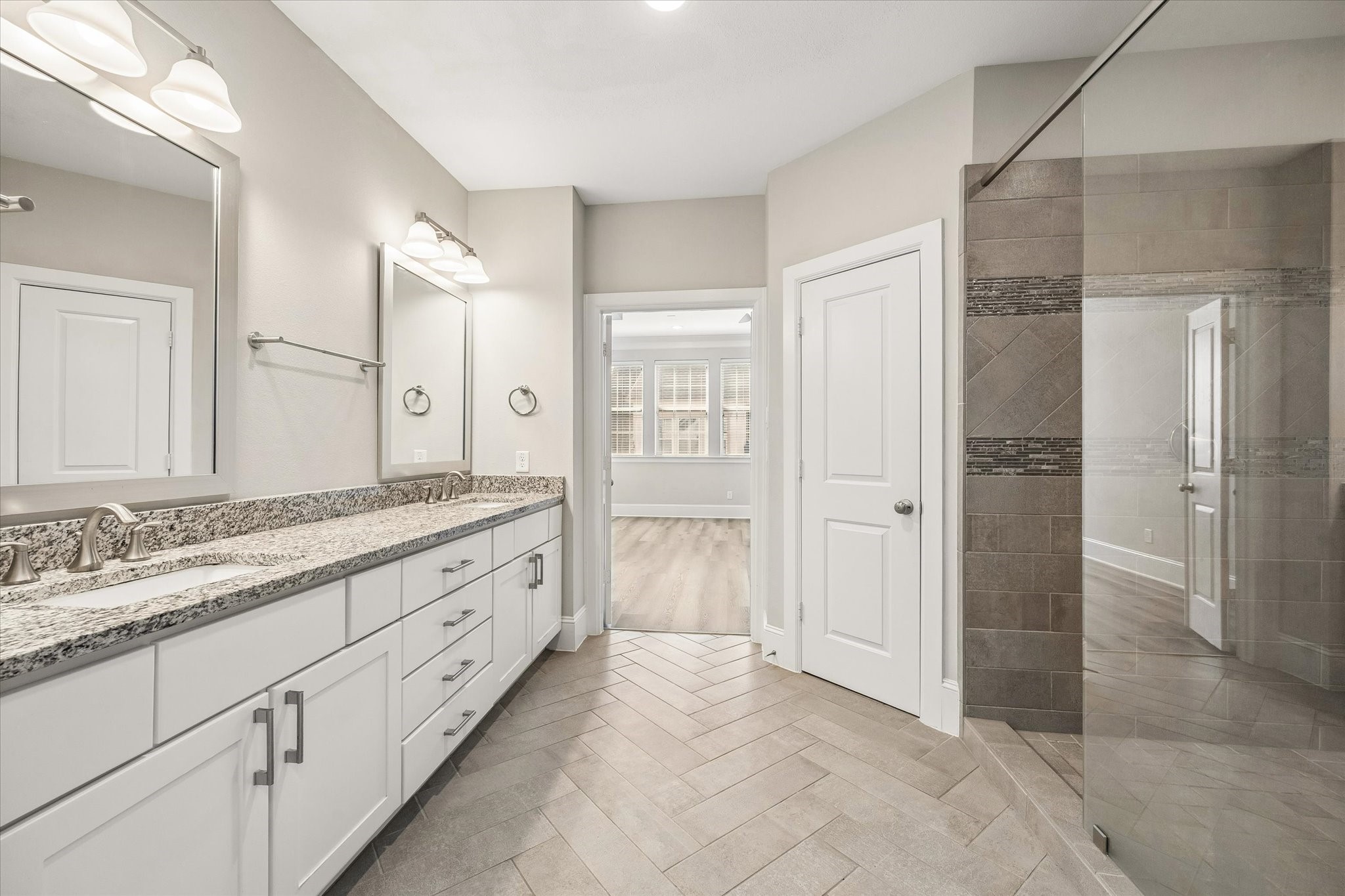 8318 Ginger Oak Street Houston, TX 77055 - Photo 10 of 20 a spacious bathroom with double vanity and mirrors