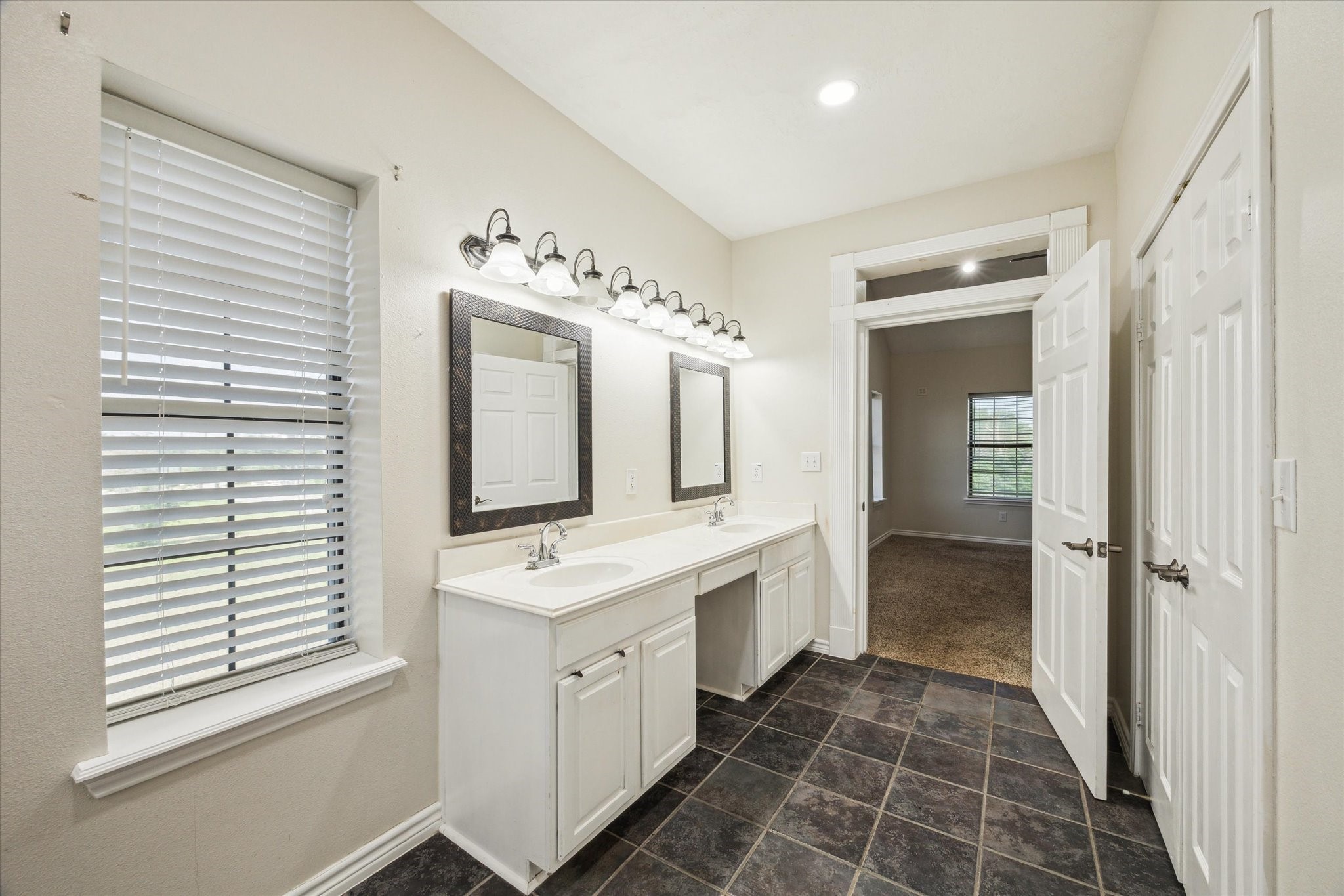 216 Rue Orleans Street Baytown, TX 77520 - Photo 23 of 43 a bathroom with a double vanity sink mirror and shower
