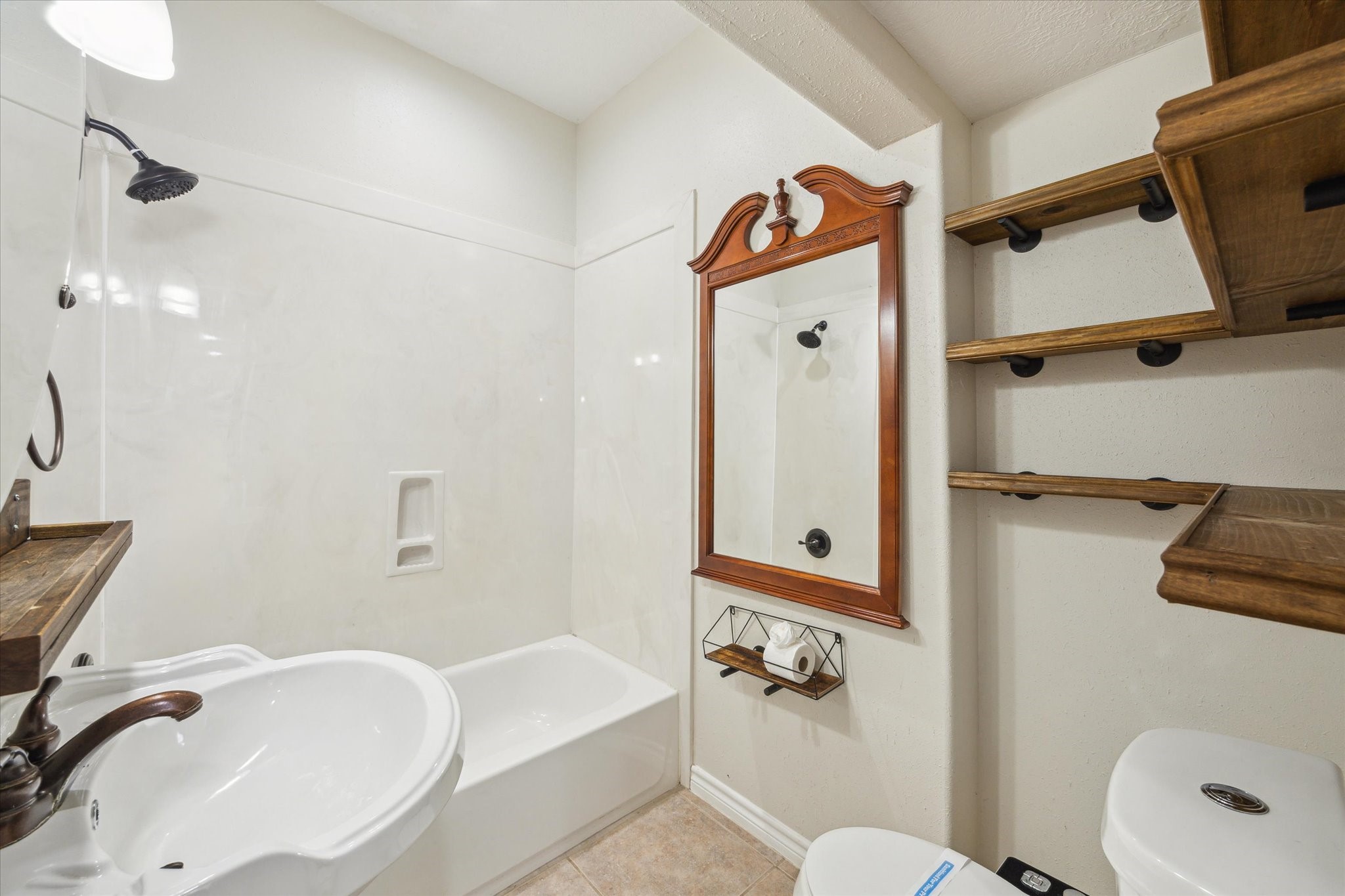 216 Rue Orleans Street Baytown, TX 77520 - Photo 25 of 43 a bathroom with a sink a toilet and shower