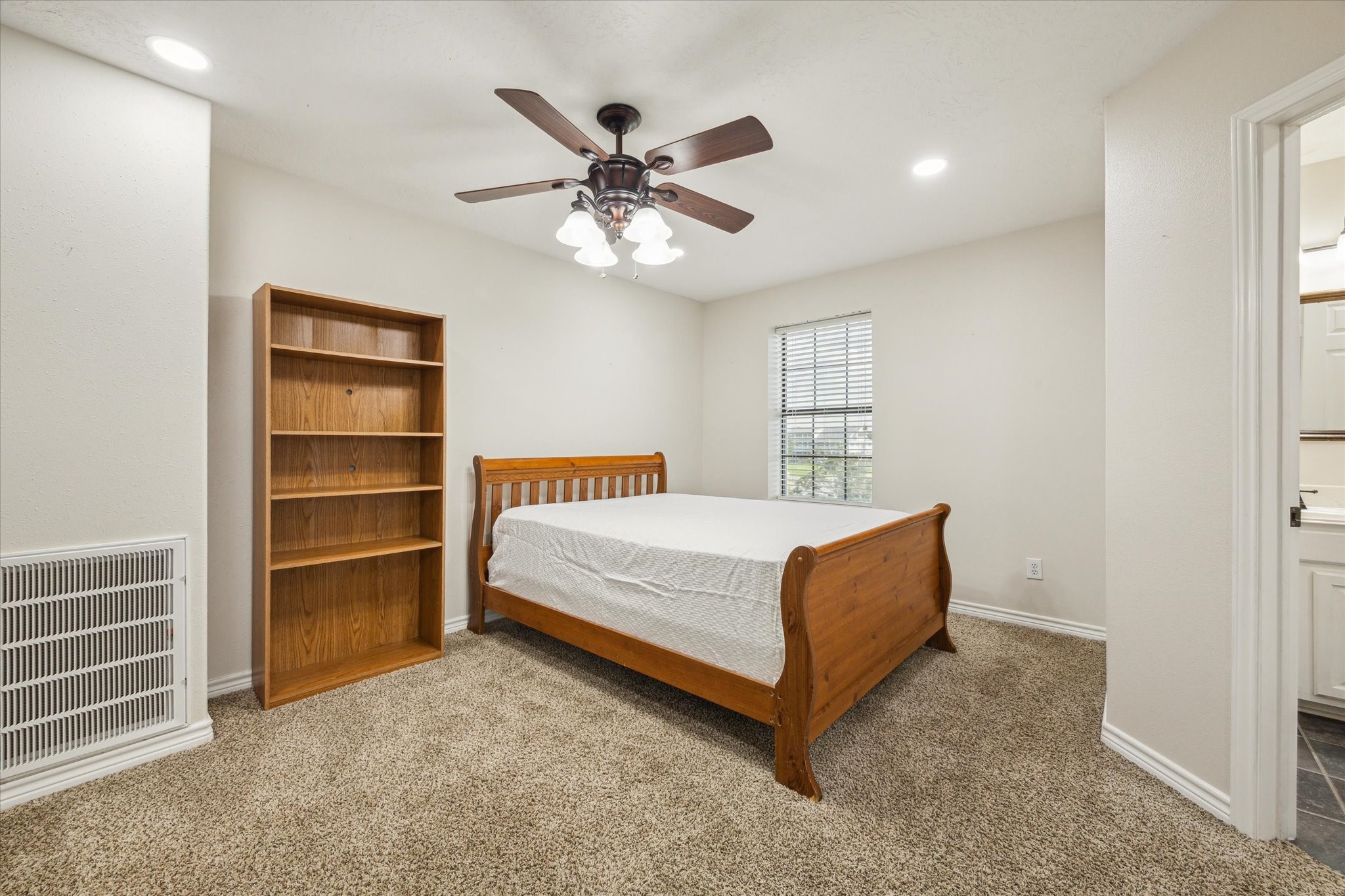 216 Rue Orleans Street Baytown, TX 77520 - Photo 35 of 43 a bed room with a bed and a ceiling fan