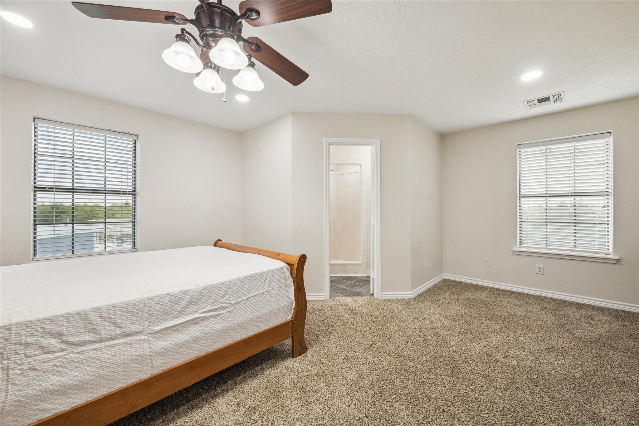 216 Rue Orleans Street Baytown, TX 77520 - Photo 36 of 43 a bed sitting in a spacious bedroom next to a window