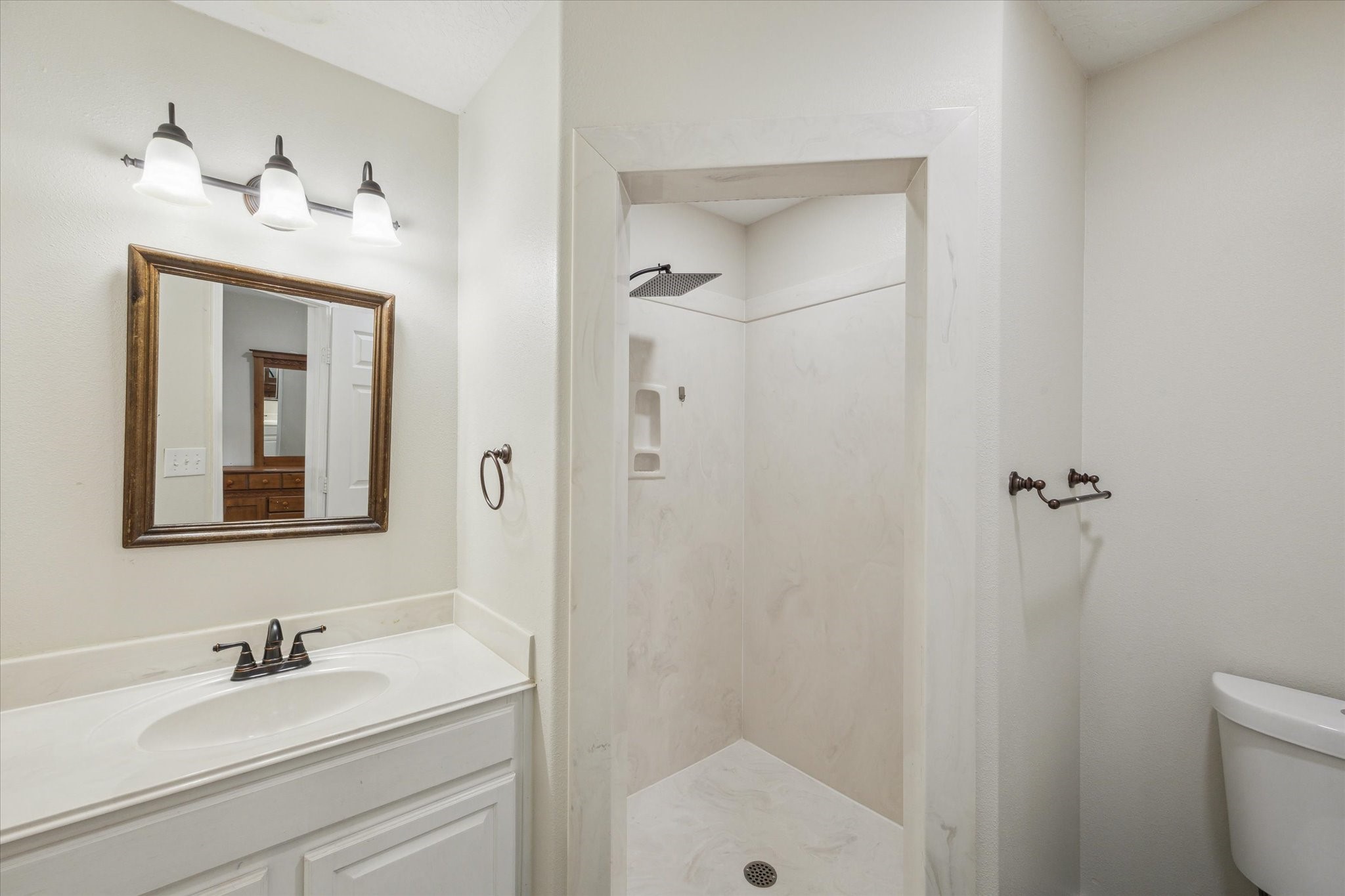 216 Rue Orleans Street Baytown, TX 77520 - Photo 37 of 43 a bathroom with a sink a toilet and shower