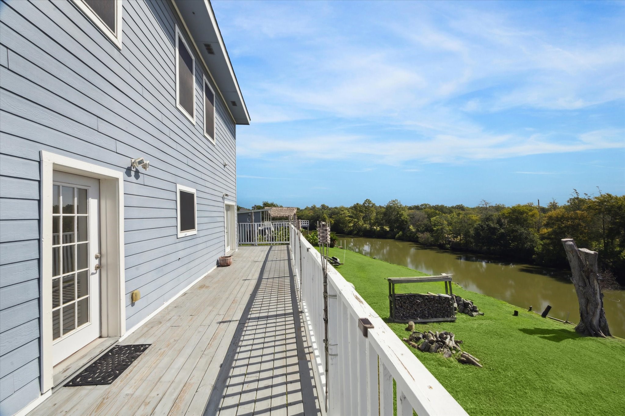 216 Rue Orleans Street Baytown, TX 77520 - Photo 40 of 43 a view of a balcony with wooden floor and lake view