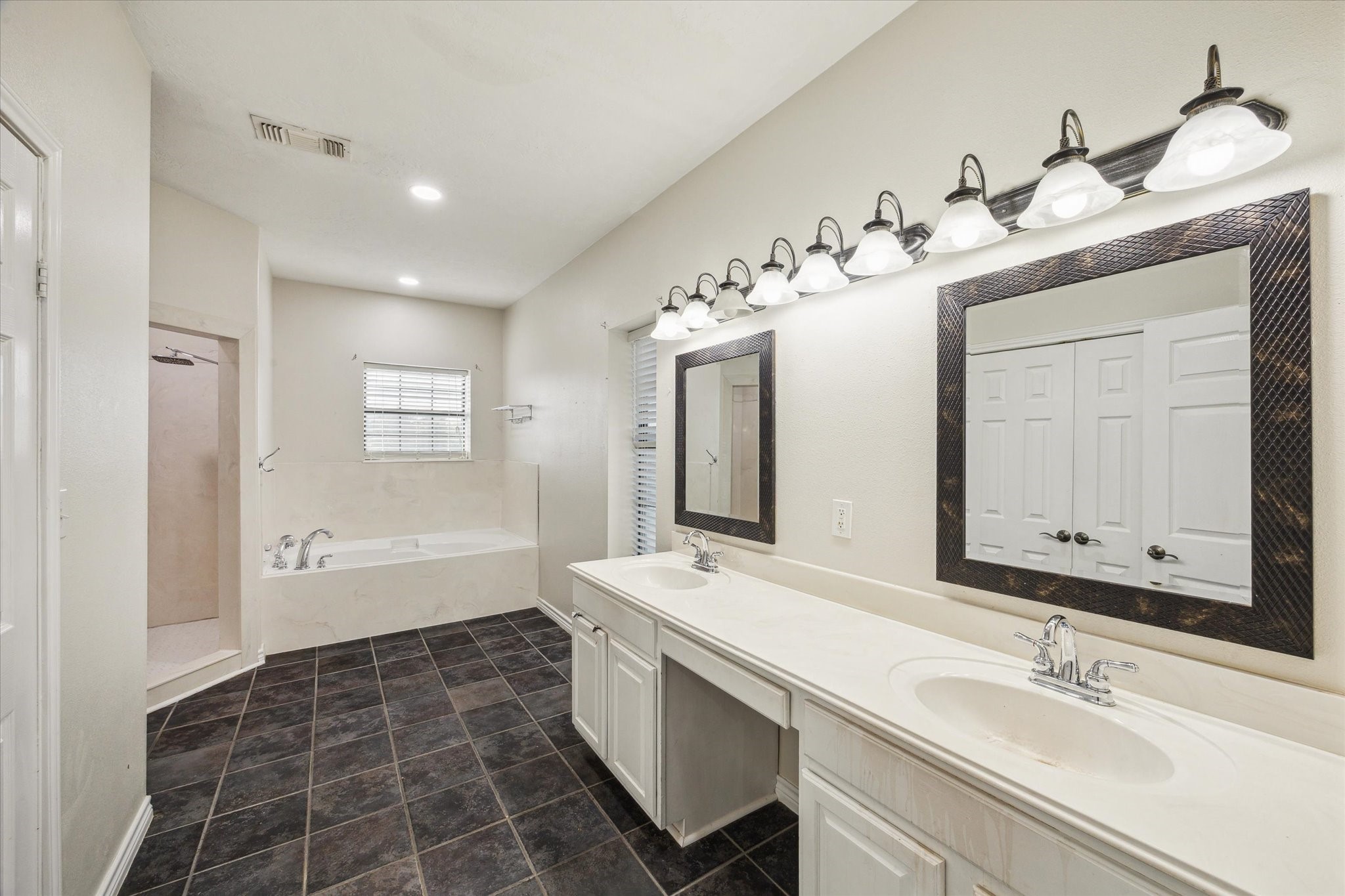 216 Rue Orleans Street Baytown, TX 77520 - Photo 4 of 43 a bathroom with a double vanity sink mirror and bathtub