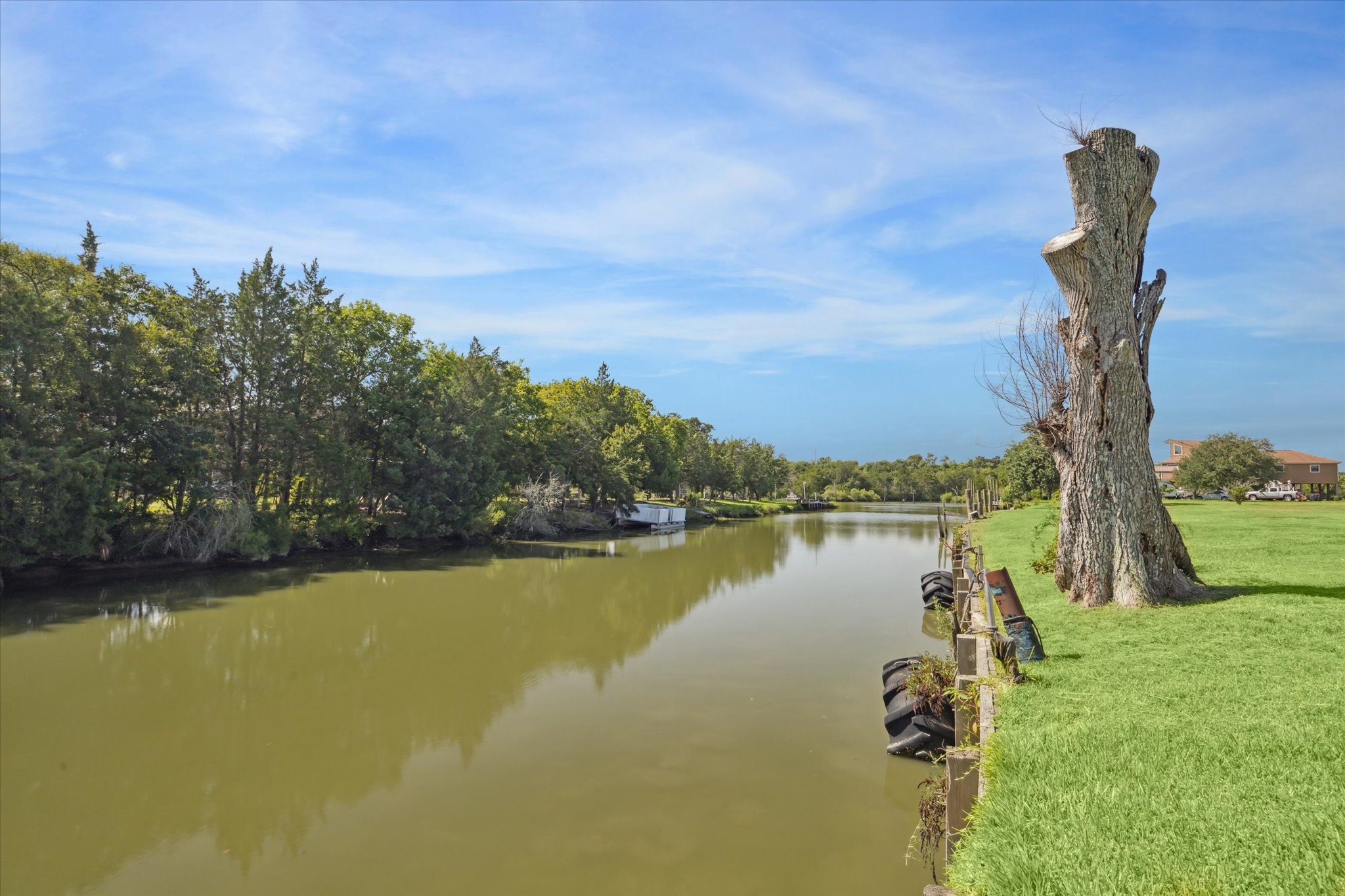 216 Rue Orleans Street Baytown, TX 77520 - Photo 43 of 43 a view of a lake with a yard and mountain view