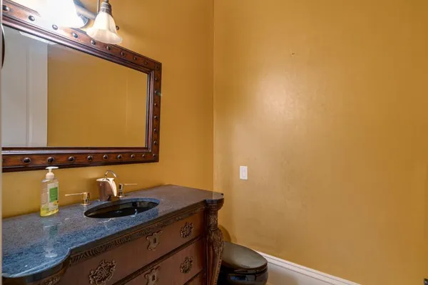 a bathroom with a granite countertop sink a large mirror and a shower