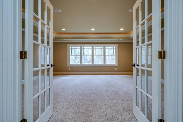 a view of a hallway with a chandelier fan