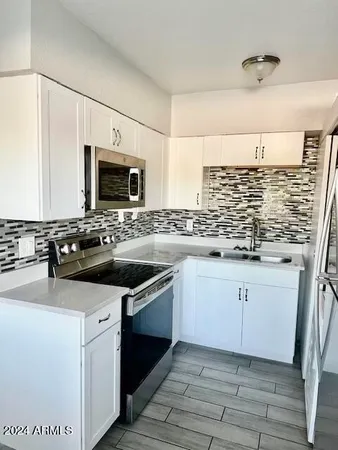 a kitchen with granite countertop a sink and a stove