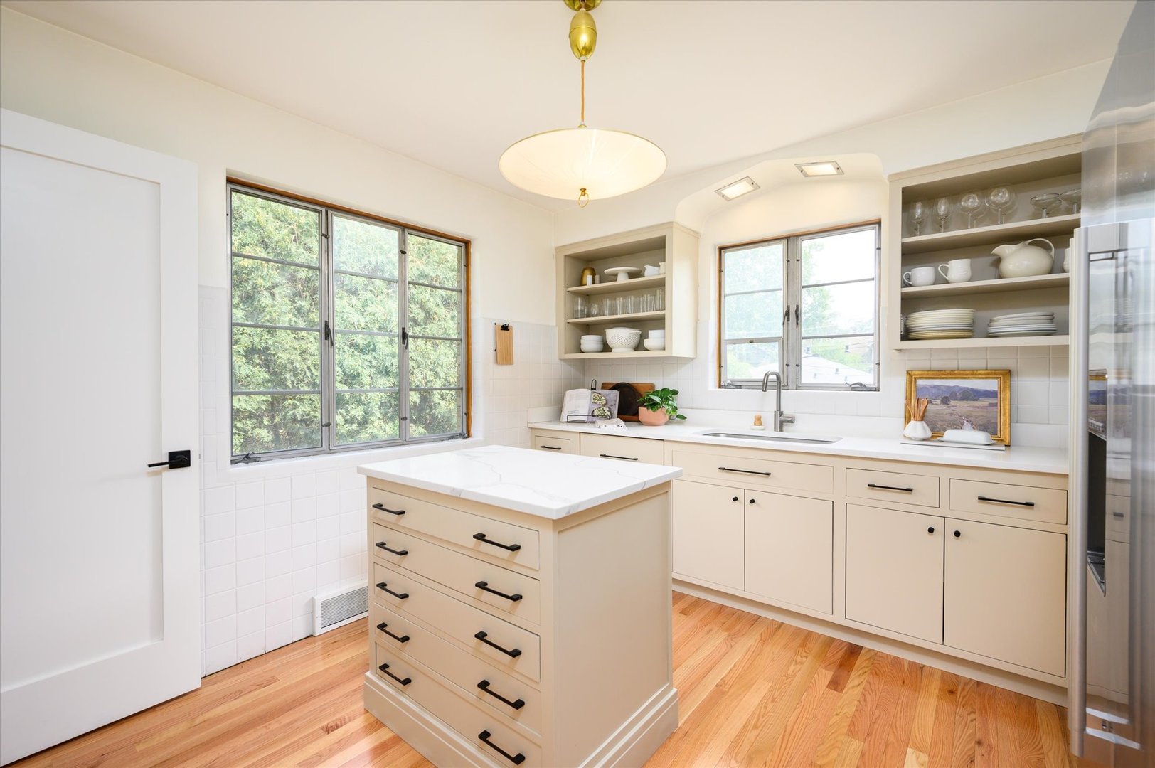 277 Olmsted Road Riverside, IL 60546 - Photo 11 of 34 a kitchen with a sink window and cabinets