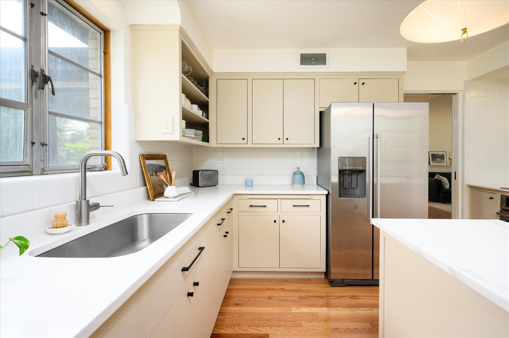 277 Olmsted Road Riverside, IL 60546 - Photo 12 of 34 a kitchen with a refrigerator sink and cabinets