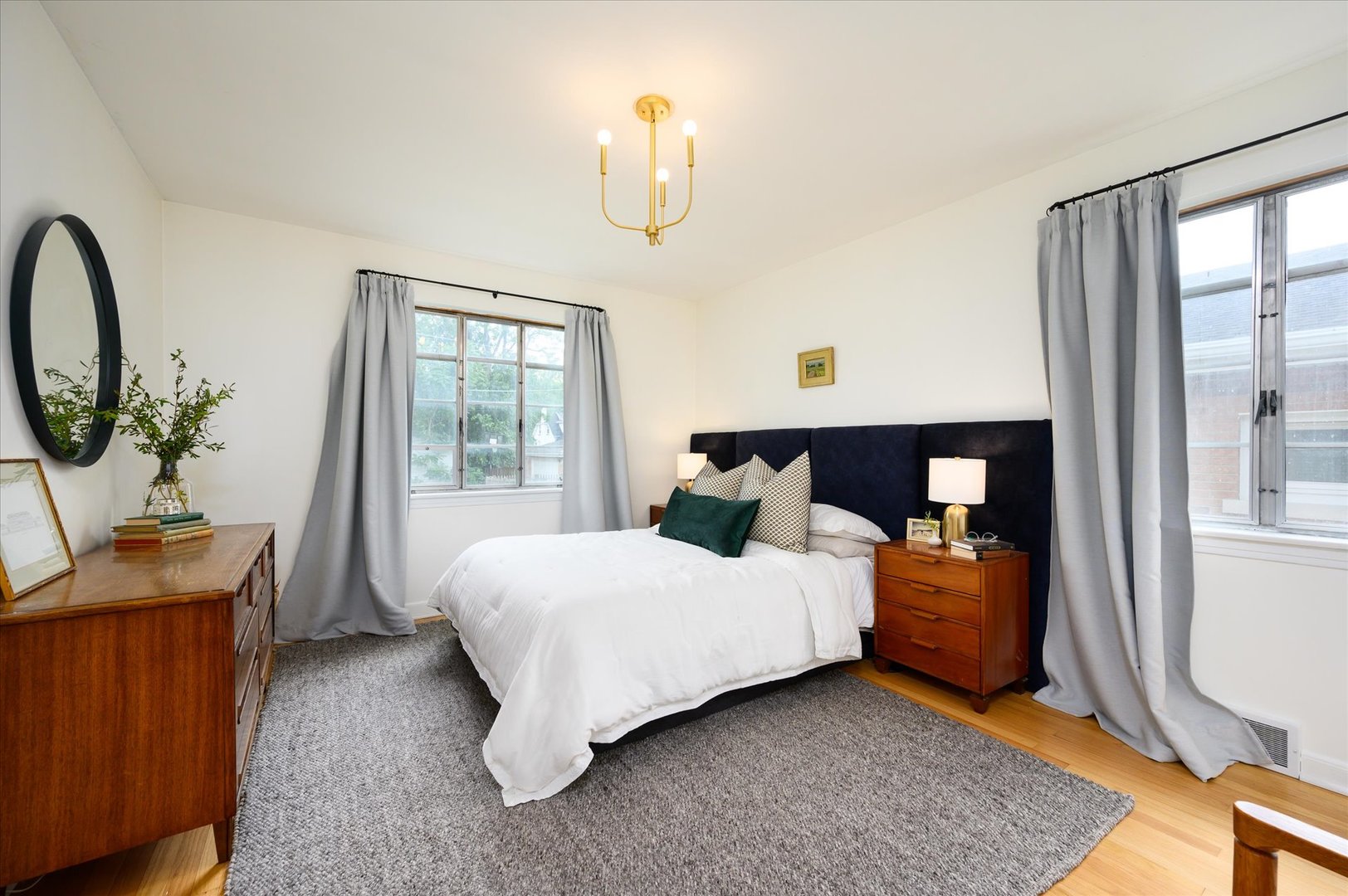 277 Olmsted Road Riverside, IL 60546 - Photo 14 of 34 a bedroom with a bed a chandelier and mirror