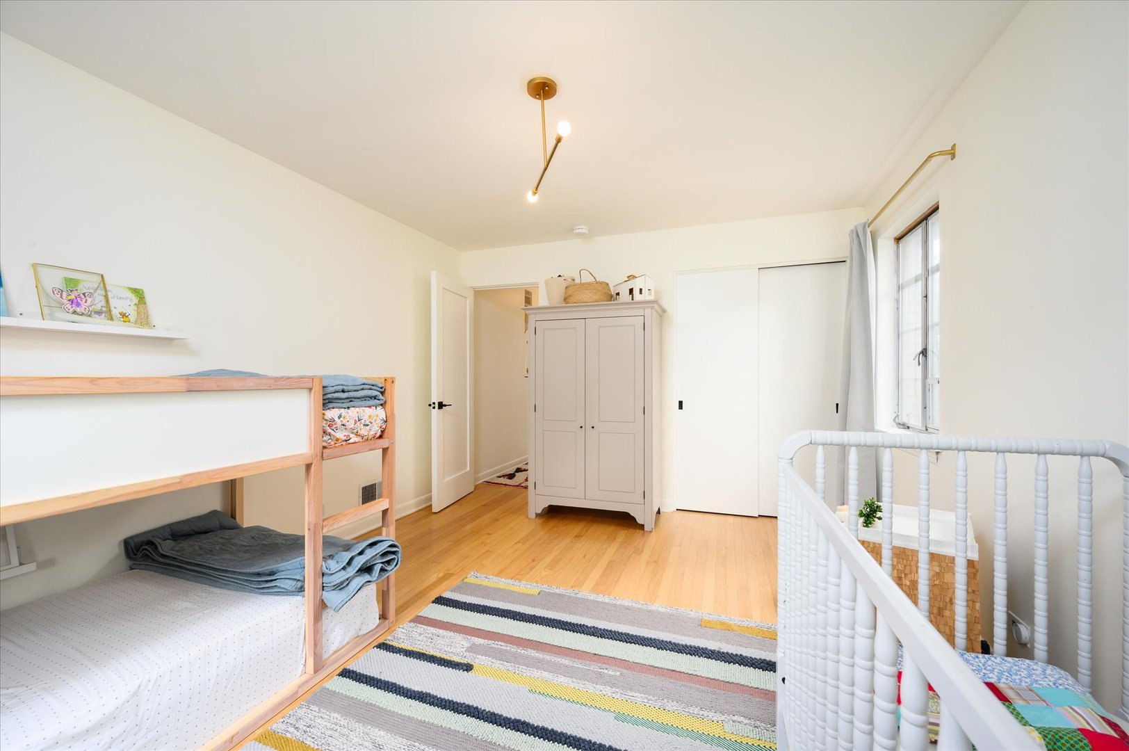 277 Olmsted Road Riverside, IL 60546 - Photo 18 of 34 a bedroom with a bed and a chandelier