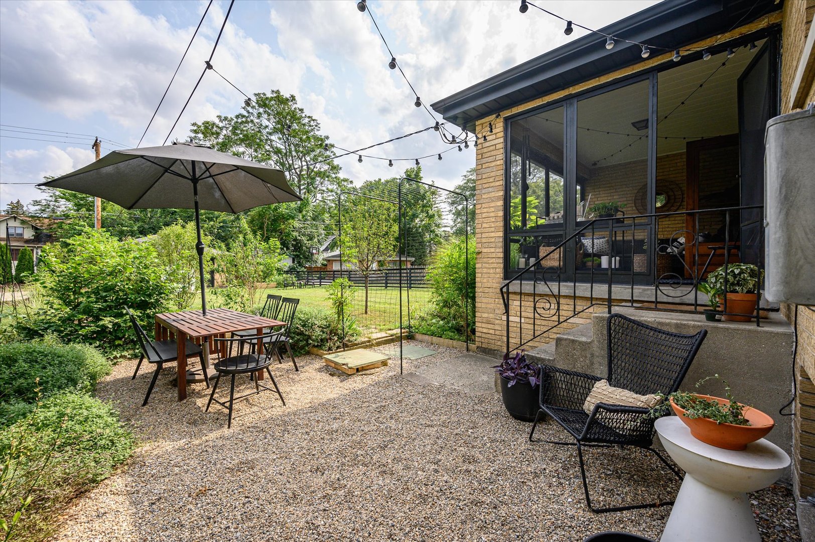 277 Olmsted Road Riverside, IL 60546 - Photo 31 of 34 a backyard of a house with table and chairs
