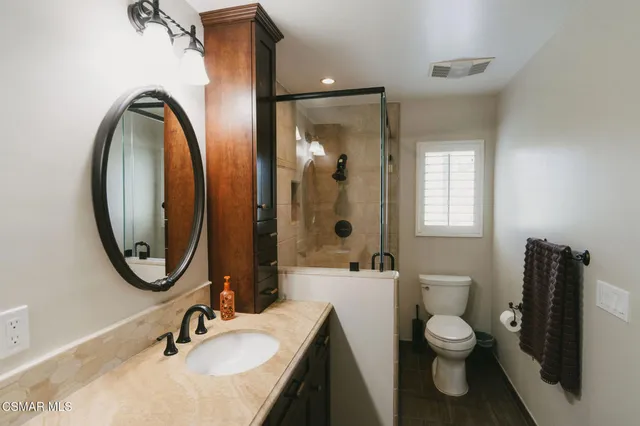 a bedroom with a bed and a dresser in it