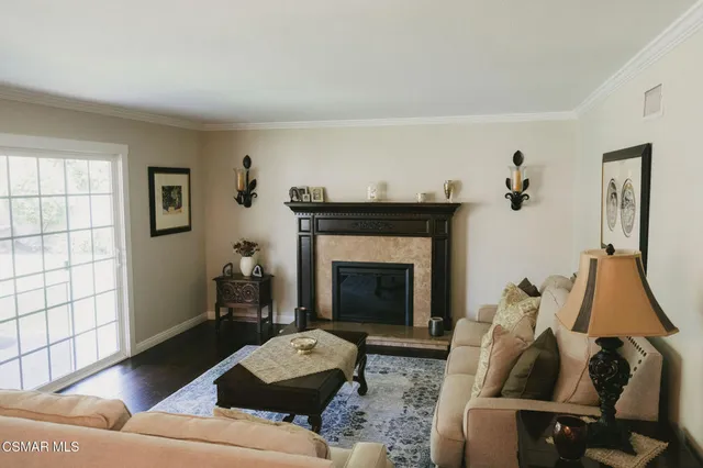 a living room with furniture and a fireplace