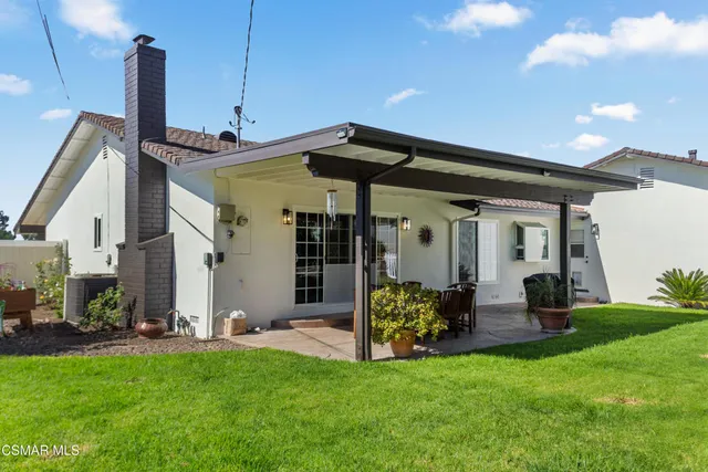 a balcony with furniture and potted plants