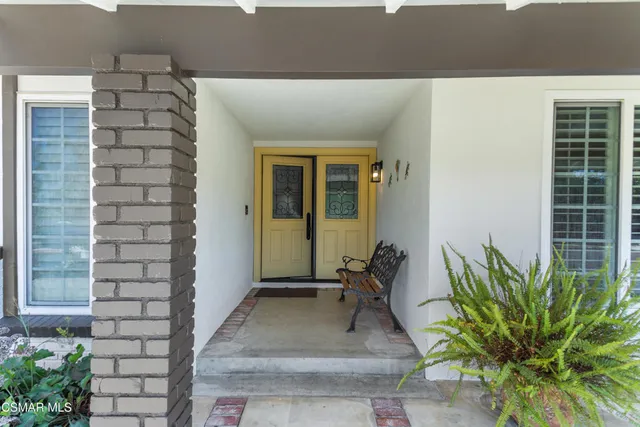 a view of a hallway with living room and dining room