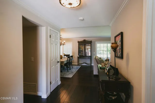 a kitchen with a stove a refrigerator a sink a dining table and chairs