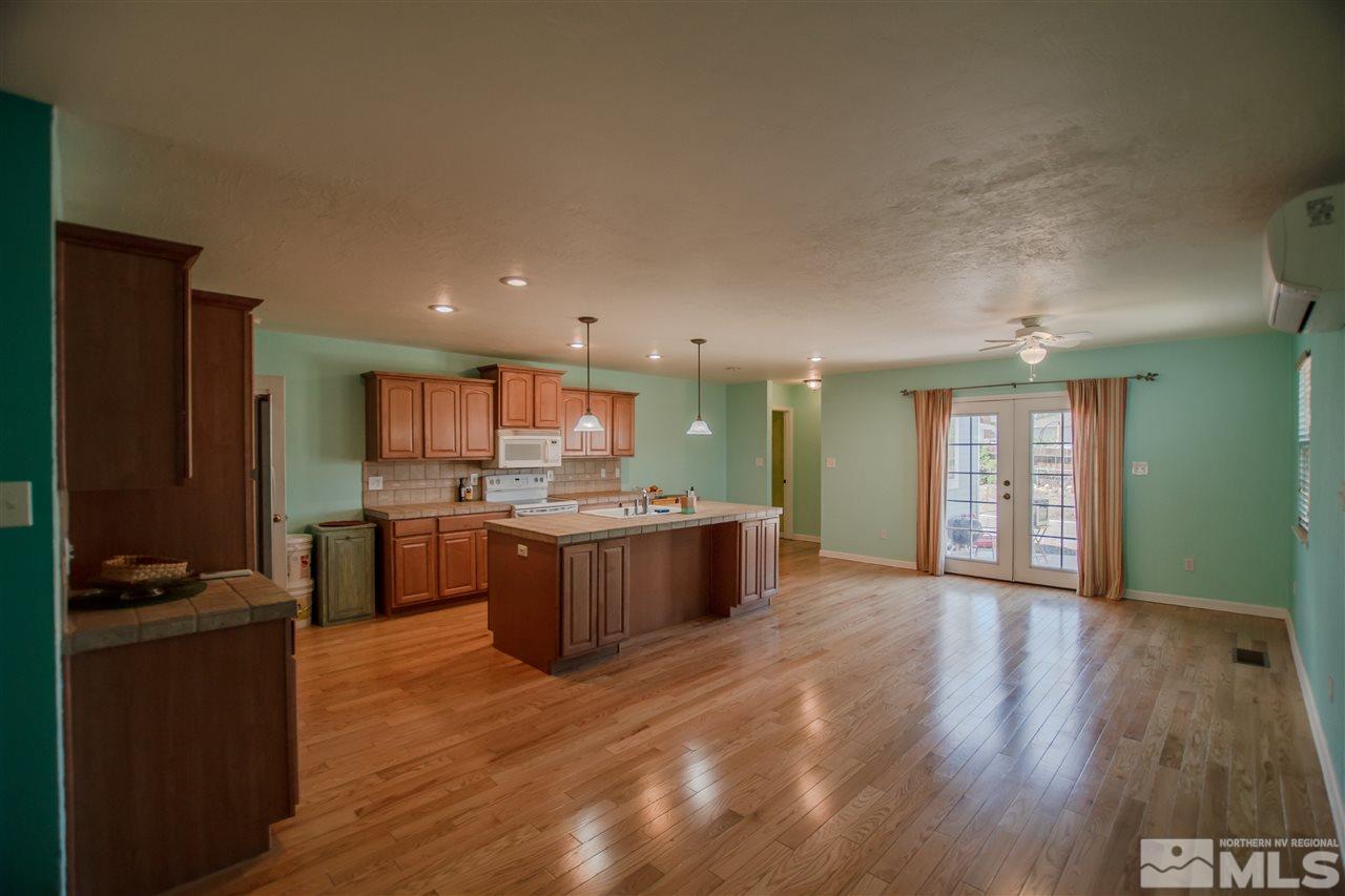 255 West Plumb Lane, Unit NV Reno, NV 89509 - Photo 7 of 25 a view of kitchen with kitchen island wooden floors appliances