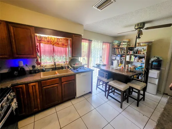 a kitchen with a sink cabinets and appliances