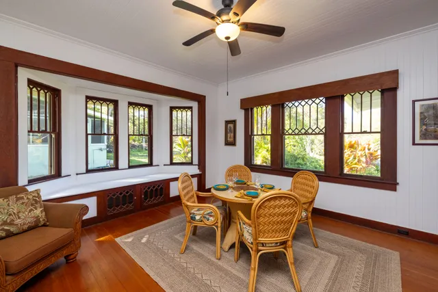 a dining room with furniture a window and wooden floor