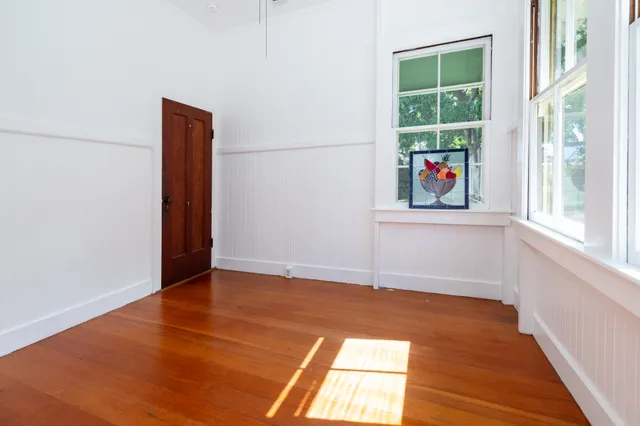 a bedroom with a bed window and a dresser