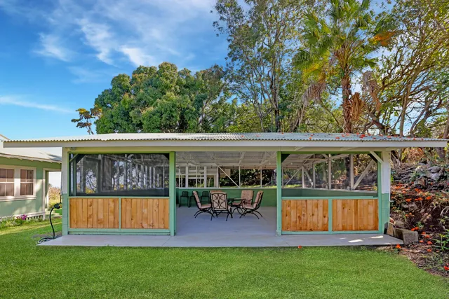 a view of a patio with table and chairs and potted plants