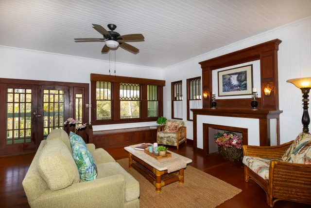a living room with furniture fireplace and a large window