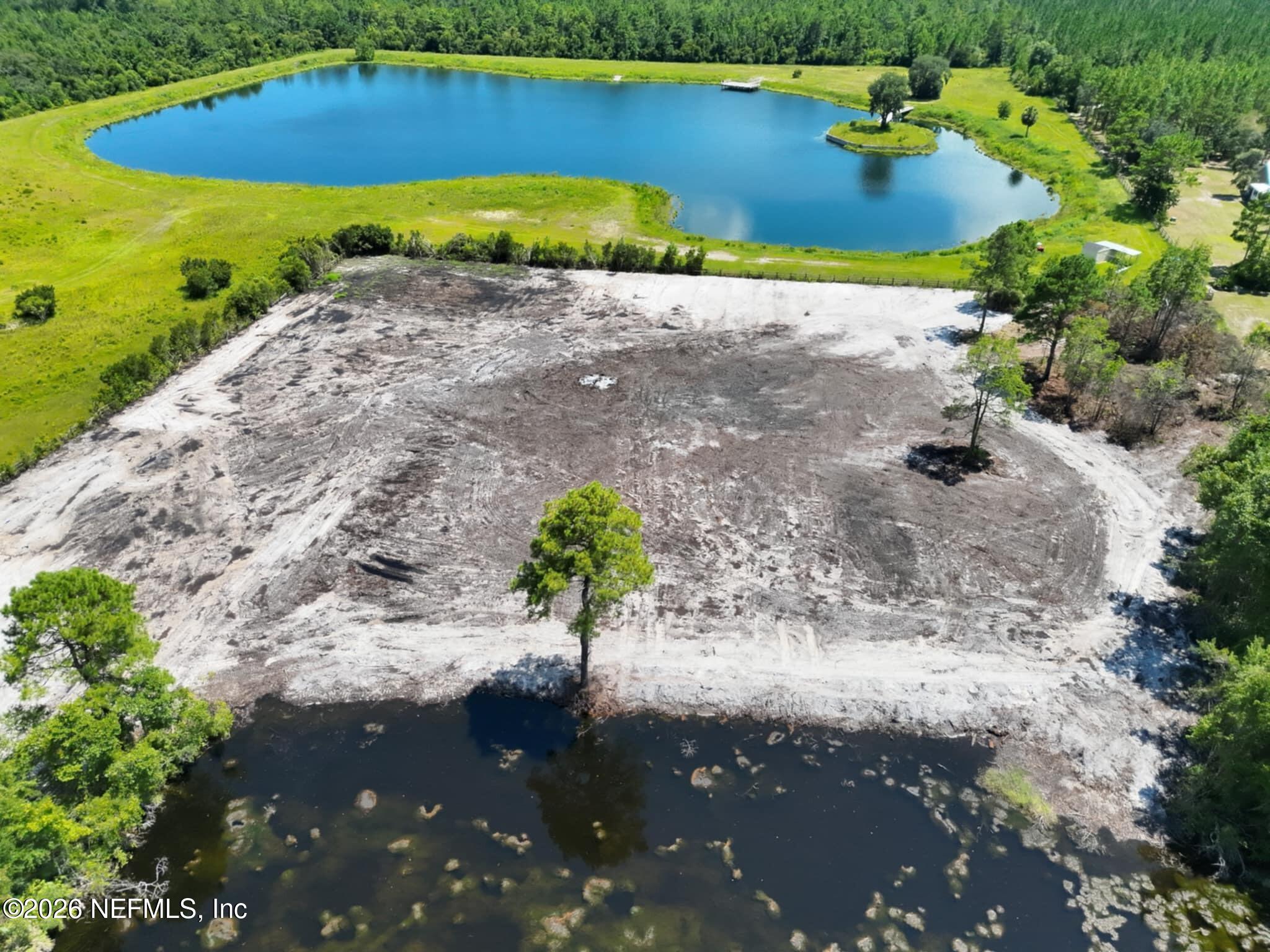 0 Quail Road Callahan, FL 32011 - Photo 4 of 7 a view of a lake with beach
