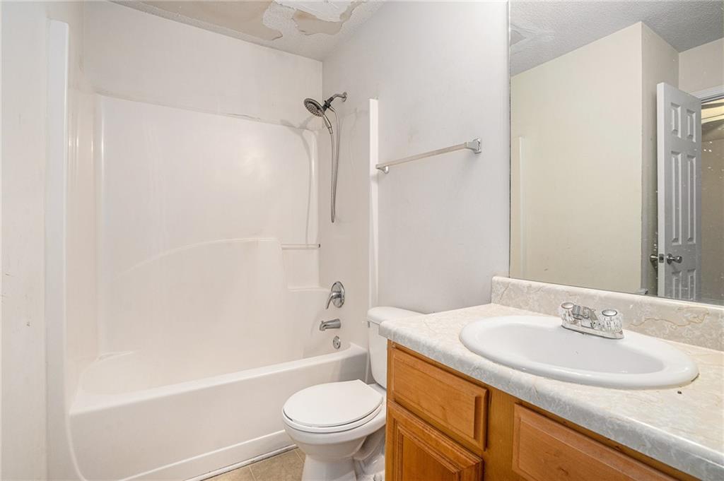 1915 Cornerstone Pass Way Conyers, GA 30012 - Photo 12 of 25 a bathroom with a sink toilet and shower