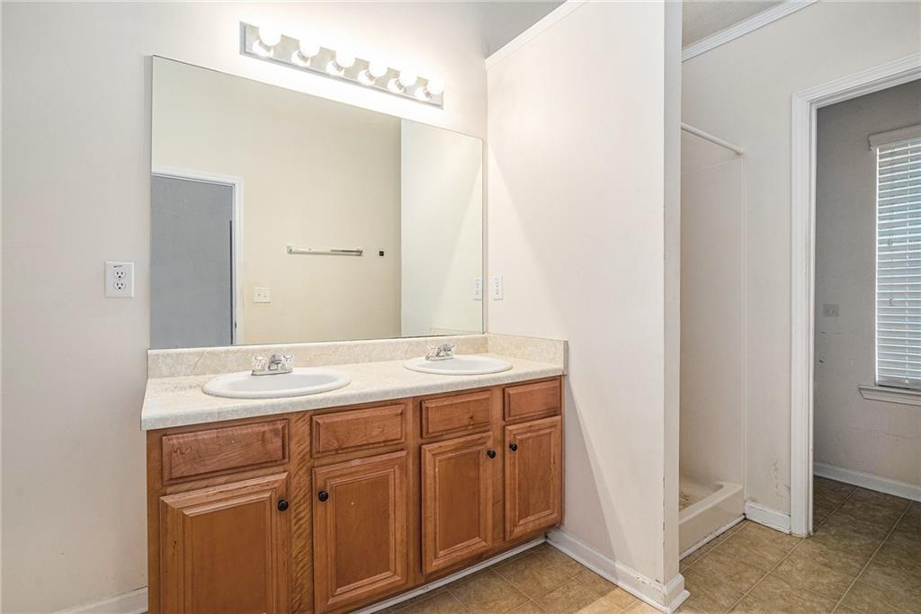 1915 Cornerstone Pass Way Conyers, GA 30012 - Photo 22 of 25 a bathroom with a granite countertop sink and a mirror